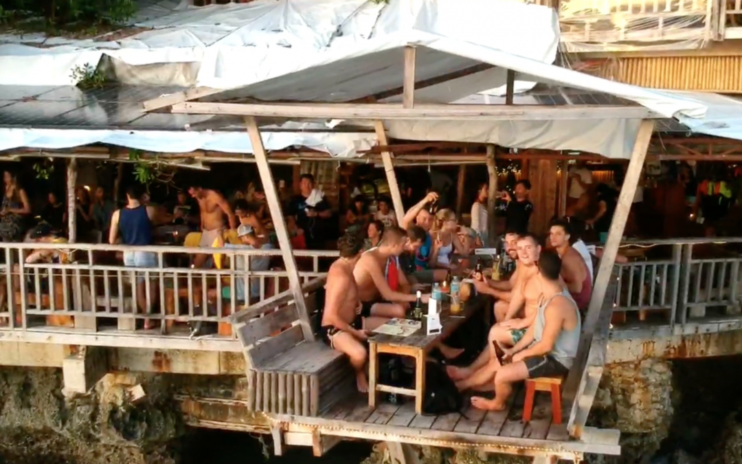 An image of a busy bar overlooking the sea